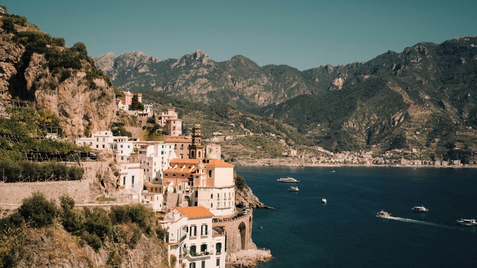 Amalfi coast village stacked above the Mediterranean beneath muted mountains